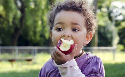 Child eating an apple United Nations food security