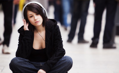 Woman wearing headphones on a street