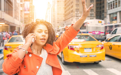 Woman on phone hailing cab