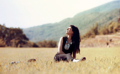 woman sitting in a field