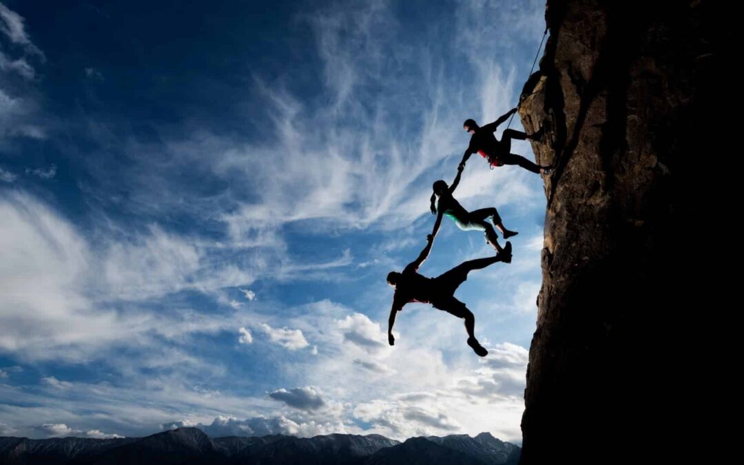 People climbing a mountain, trusting the person at the top to help them to the top