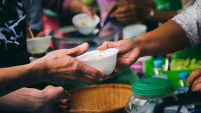 Person giving food to another
