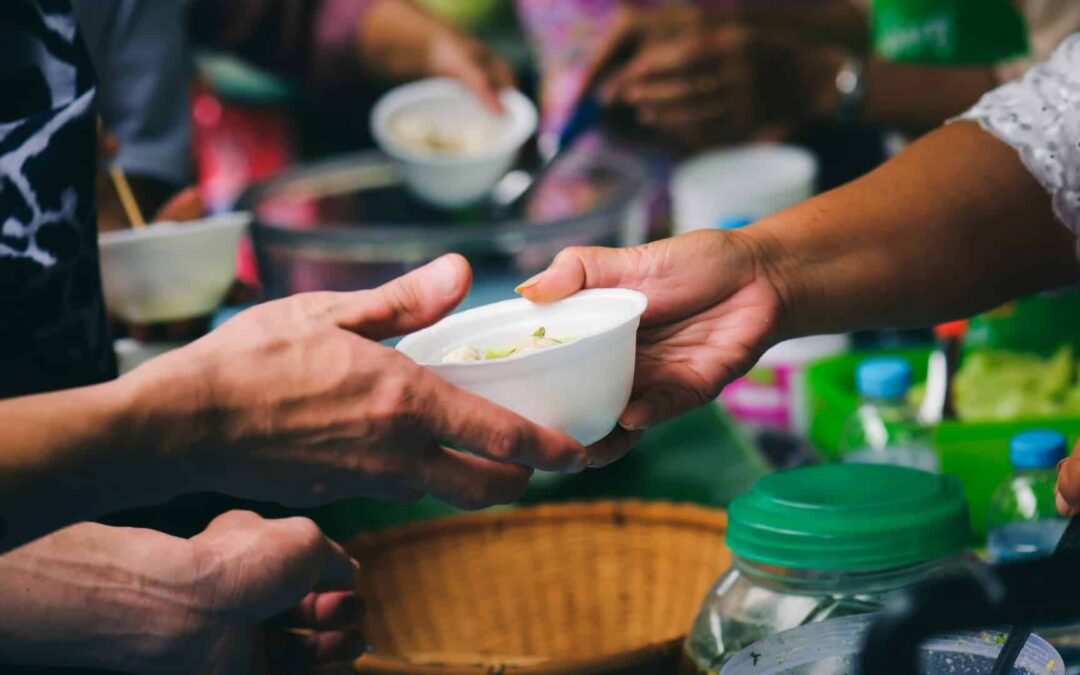 Person giving food to another