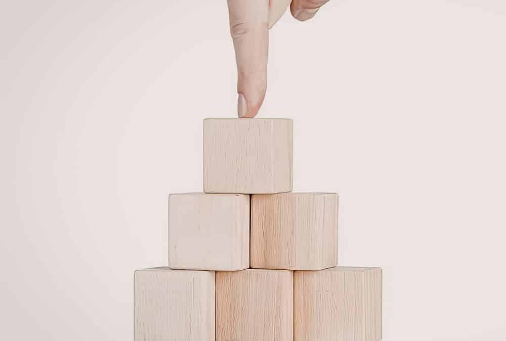 Pointed finger toward a group of building blocks