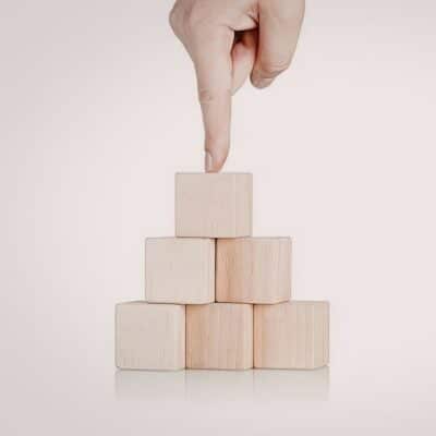 Pointed finger toward a group of building blocks